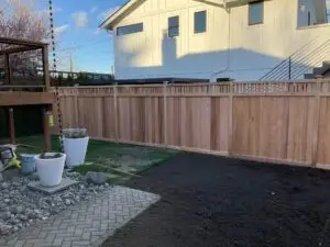 Beautiful vertical cedar fence installed in a Seattle yard, featuring natural wood tones and sturdy posts for privacy and security.