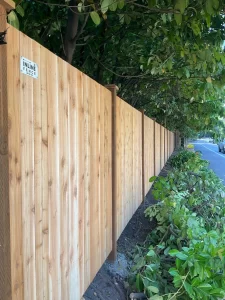 A cedar fence panel installed by Inline Fence, providing privacy and natural beauty along a residential street.
