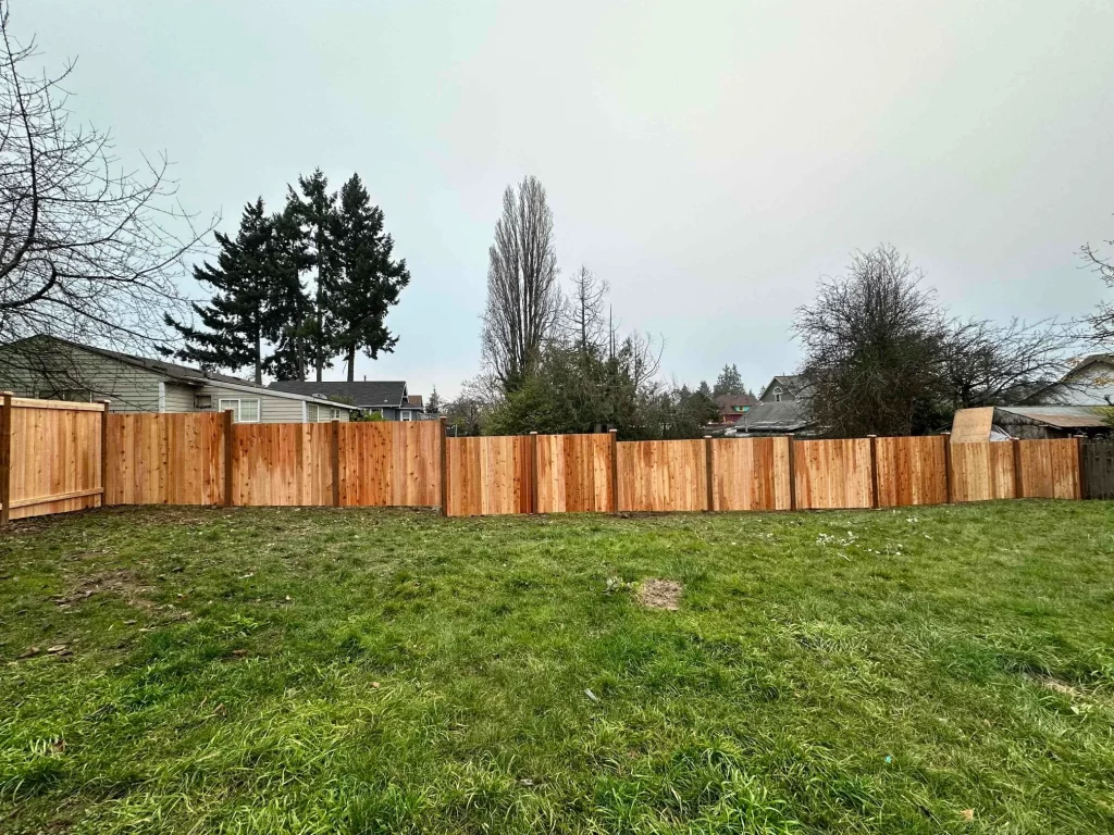 A row of cedar fence panels installed by Inline Fence, providing privacy and a clean, natural boundary in a residential yard.