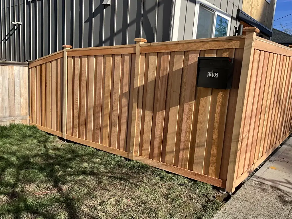 A beautiful cedar fence in Seattle with vertical slats and a mailbox, showcasing Cedar Fences Seattle's durability.