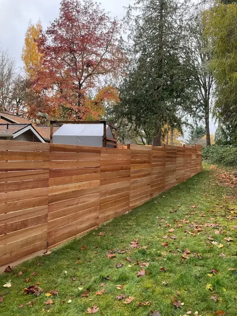 A horizontal cedar fence Seattle blending seamlessly with the surrounding greenery.