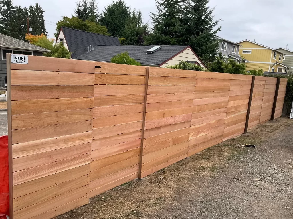 Sleek horizontal wooden fences Seattle cedar design complements the landscape, creating privacy & modern curb appeal.