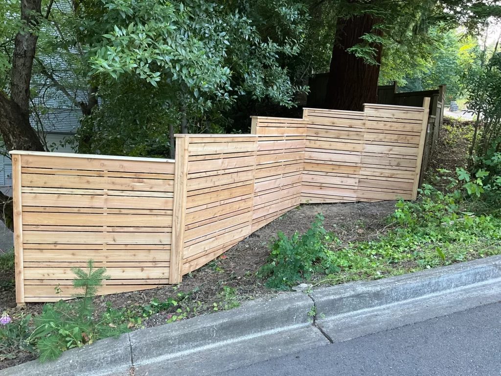 A uniquely angled horizontal fence installed along a sloped property, complying with horizontal fence height rules.