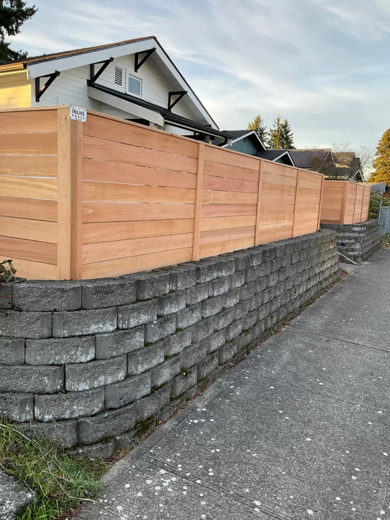 A horizontal fence on a stone base, designed with careful consideration of horizontal fence height rules for compliance.