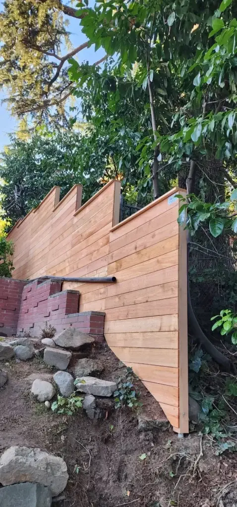 A horizontal fence on a sloped yard with natural cedar boards, showing a unique design for Seattle’s terrain.