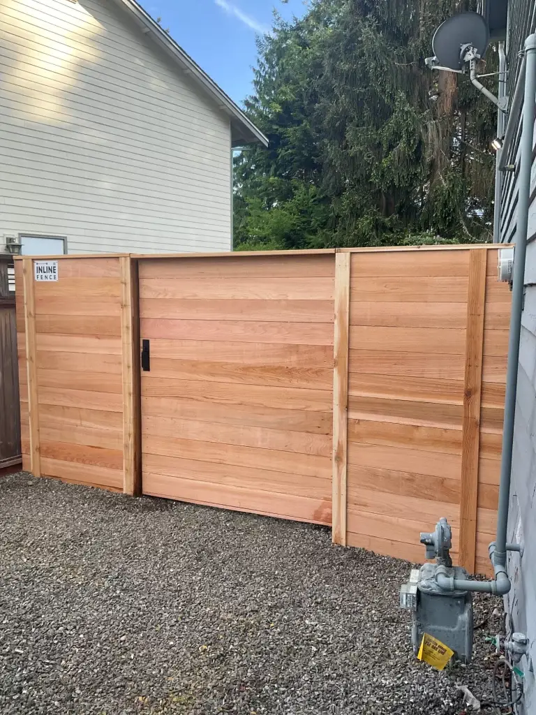 A cedar privacy fence with a gate installed by Inline Fence in a Seattle neighborhood.