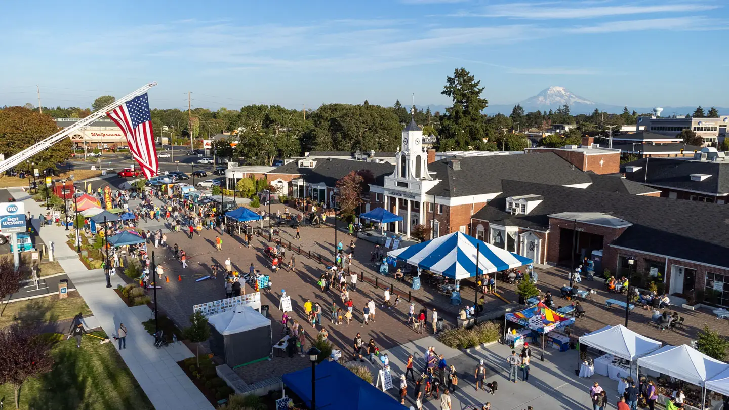 Aerial view of Federal Way, WA, with commercial buildings, parking, and Puget Sound.