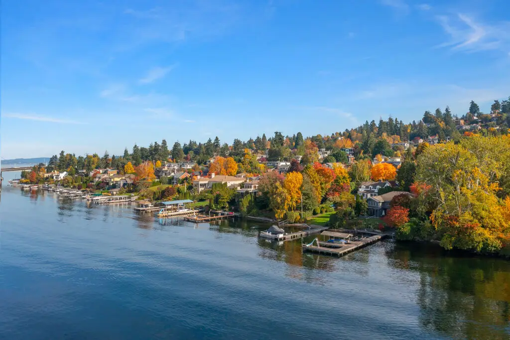 Aerial view of Mercer Island, WA waterfront with homes and autumn trees.