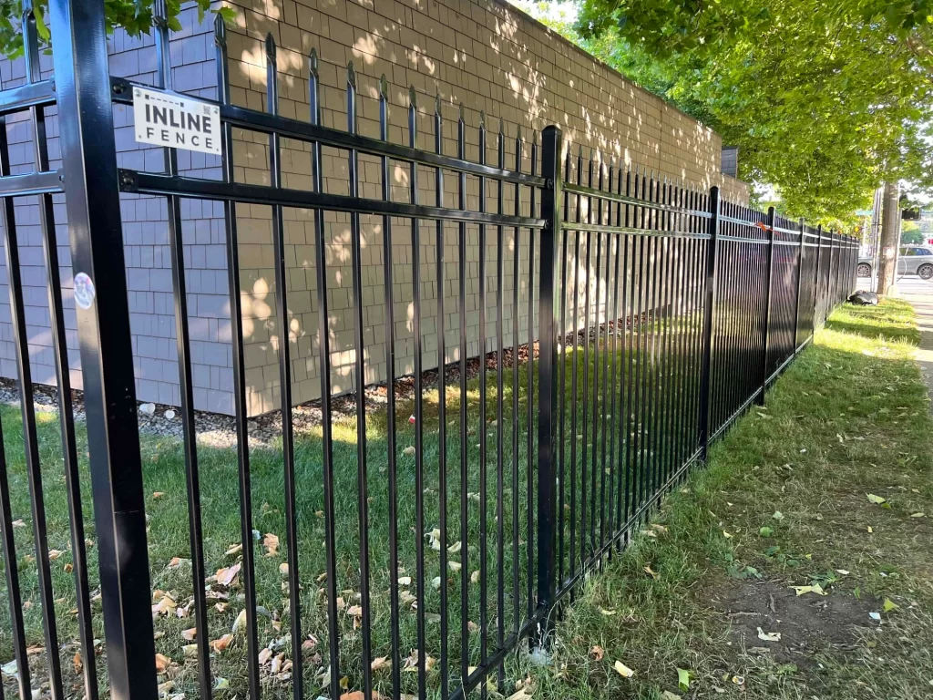 A black metal security fence, demonstrating the strength and durability of the Best fence materials for Seattle in an urban setting.