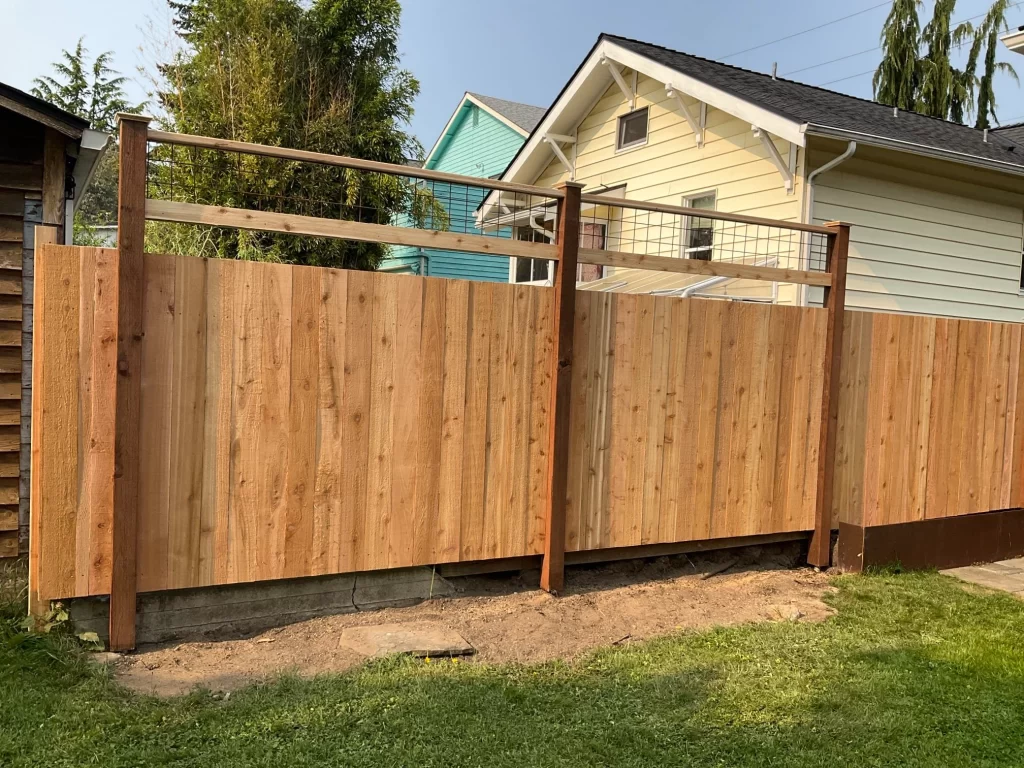 A modern cedar fence panel with a unique top design, installed by Inline Fence, providing privacy and contemporary style.