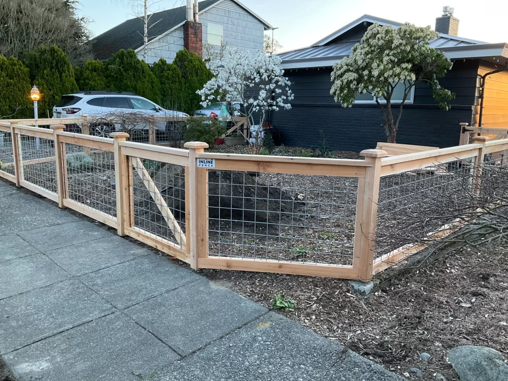 A modern residential fence featuring hog wire panels, offering security and an attractive, open design for urban properties.