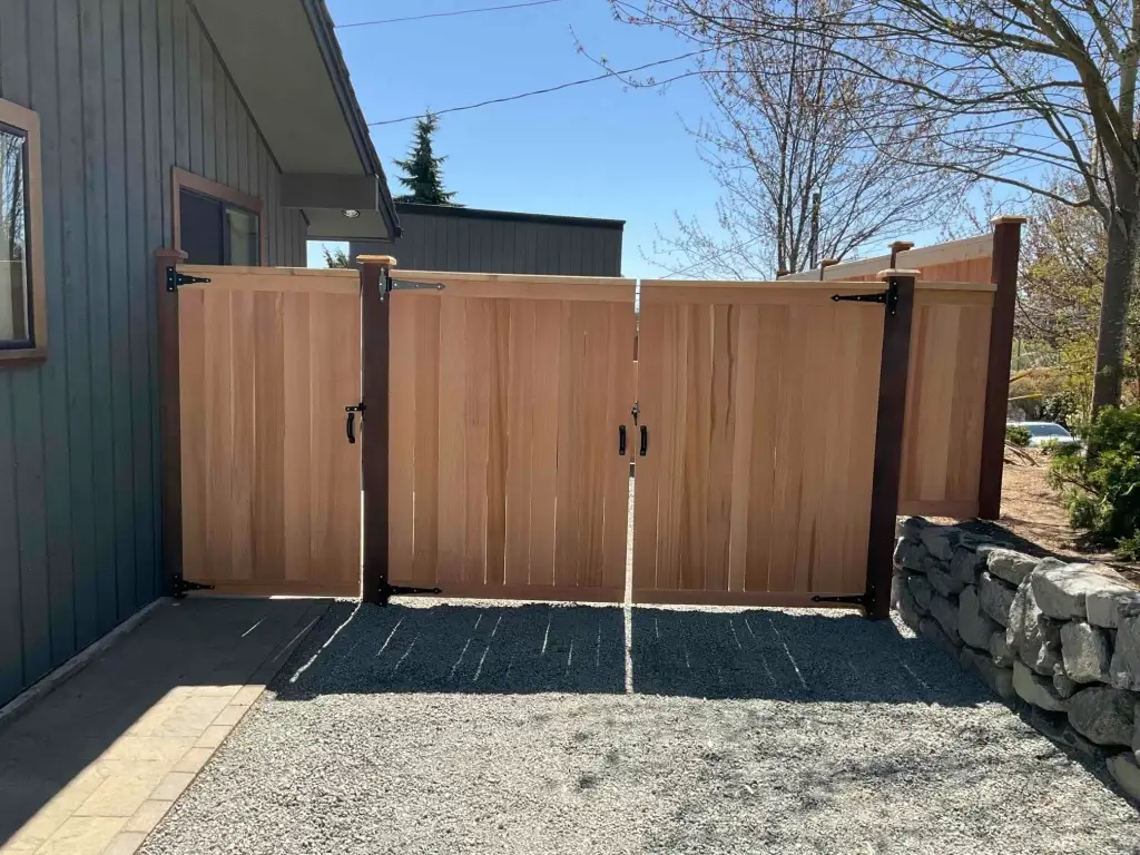 A cedar wood double gate with metal accents, perfect for Summer Fence Installation in Seattle.