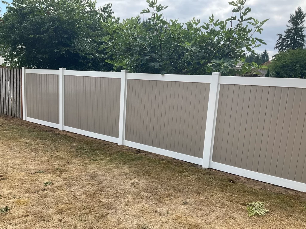 A two-tone vinyl fence with white and tan panels, offering both durability and style, reflecting the vinyl fence cost in Seattle.