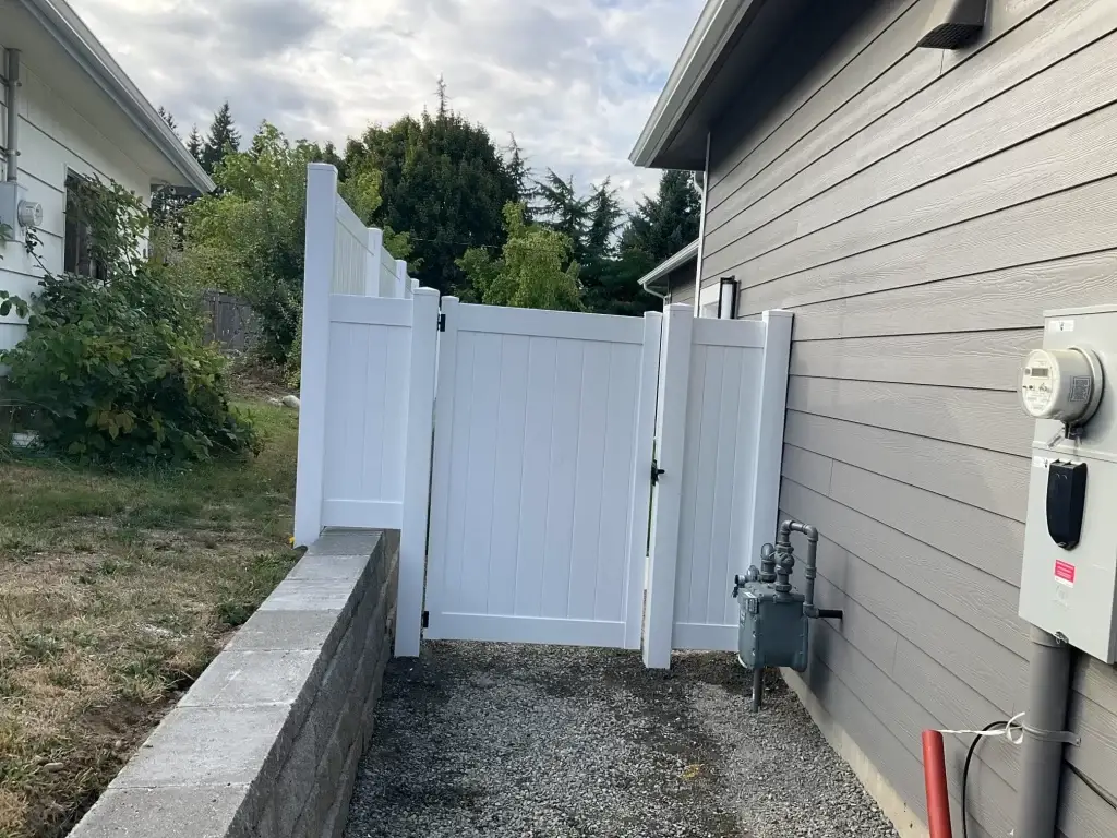 A sturdy white vinyl gate providing privacy and security for a Seattle home.